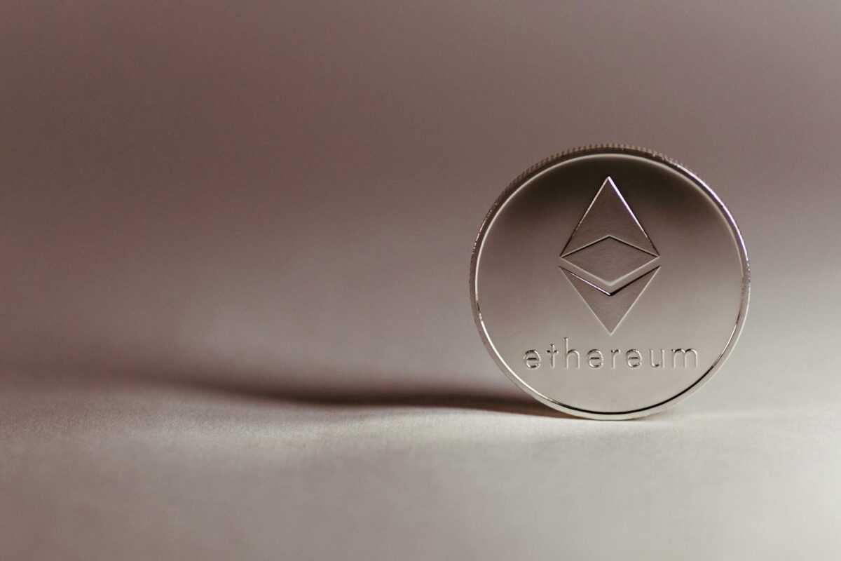 Close-up of a silver Ethereum coin symbolizing digital currency and blockchain technology.