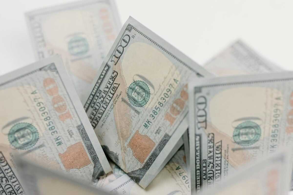 Close-up of US hundred dollar bills, ideal for finance or economic concepts.